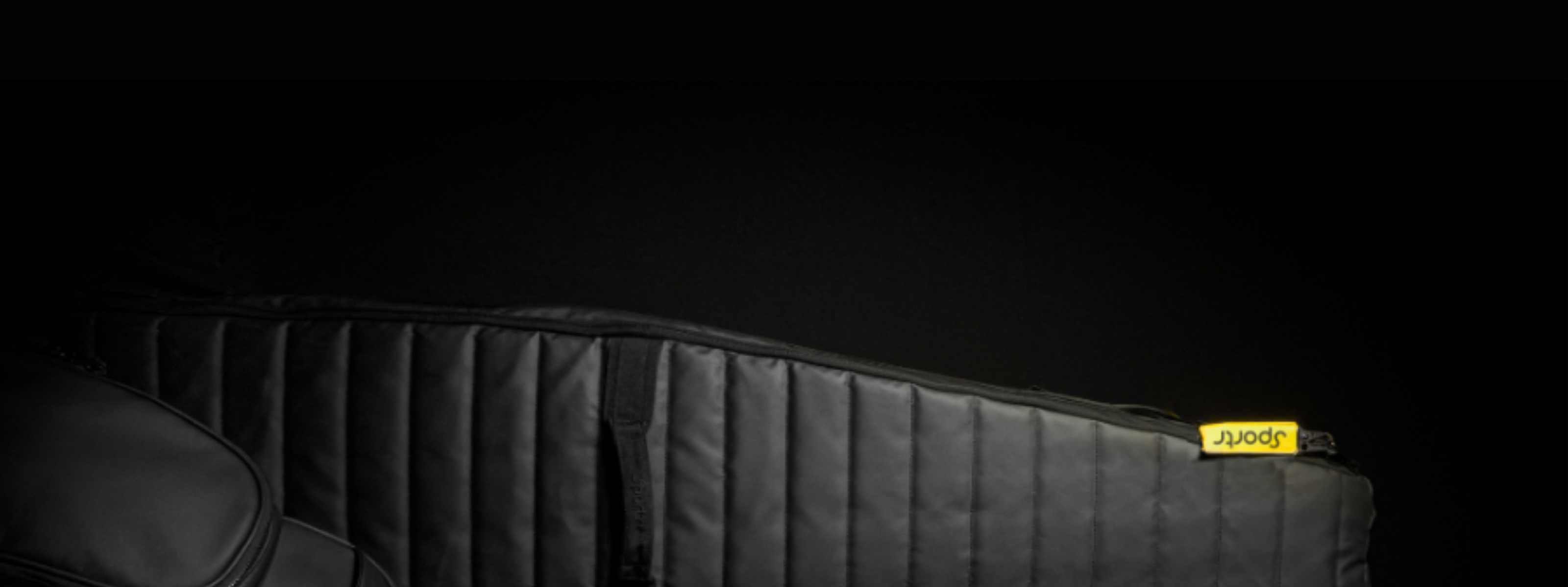 Black Sportr Golf Travel Bag with a yellow brand label on a dark background