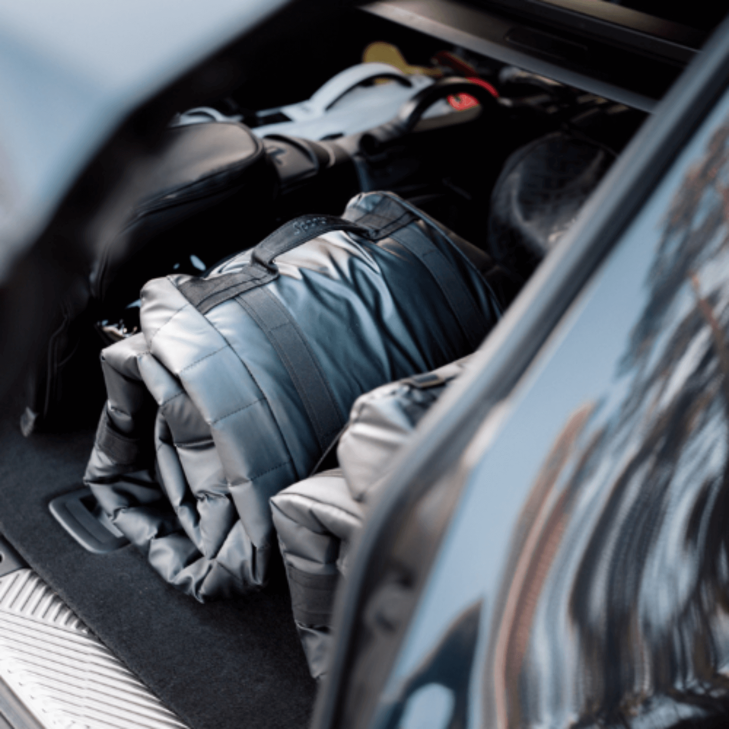 Car trunk with folded Sportr Golf Travel bags inside