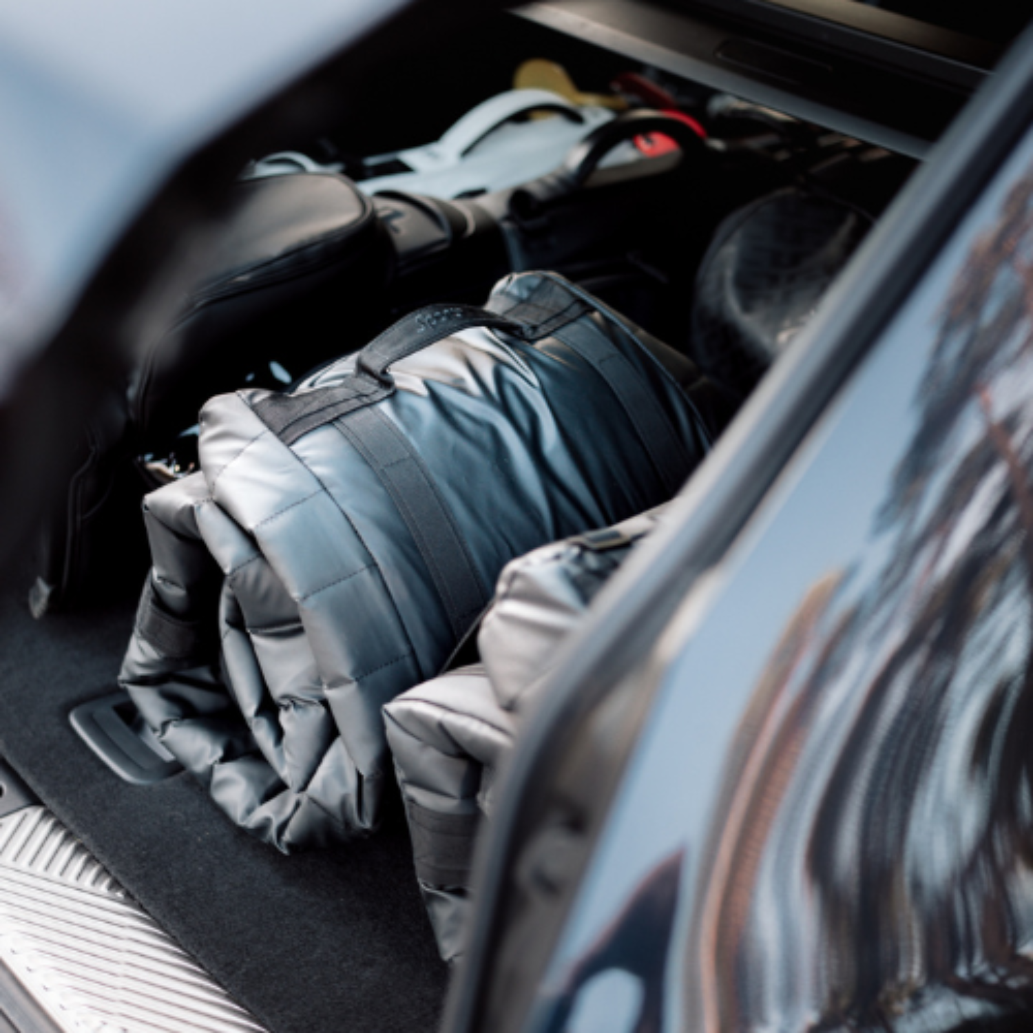 Car trunk with folded Sportr Golf Travel bags inside